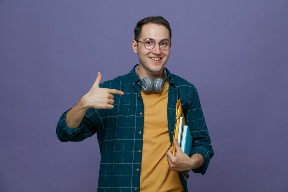 smiling-young-male-student-wearing-glasses-headphones-around-neck-holding-folder-note-book-note-pad-arm-pointing-them-looking-camera-isolated-purple-background_141793-136066